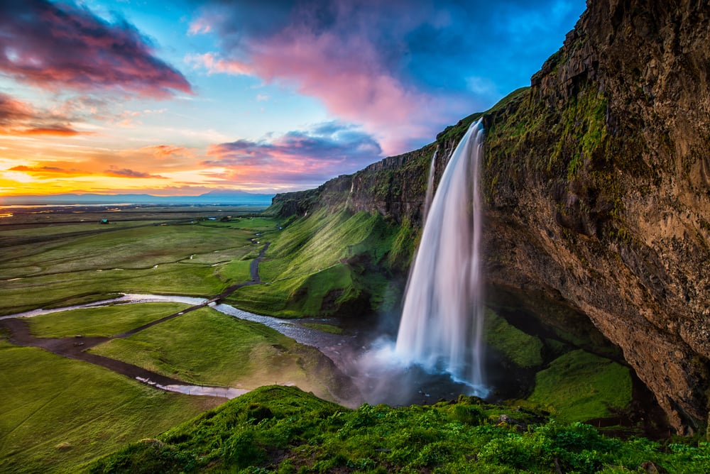 Seljalandsfoss - Seljalandsfoss is located in the South Region in Iceland right by Route 1. One of the interesting things about this waterfall is that visitors can walk behind it into a small cave.