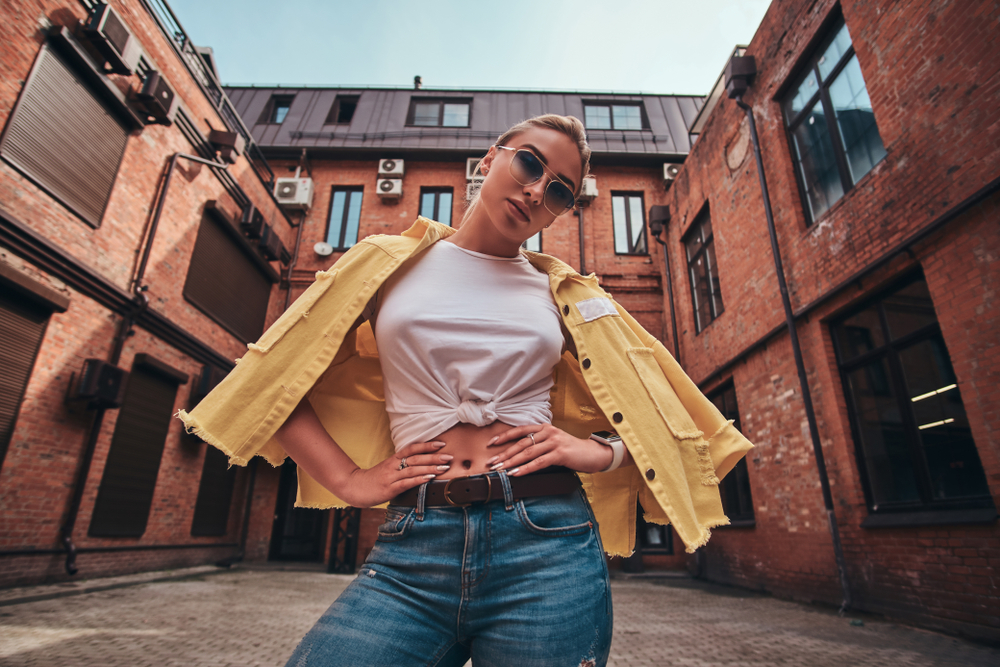 Low angle photo of woman in sunglasses in symmetrical yard