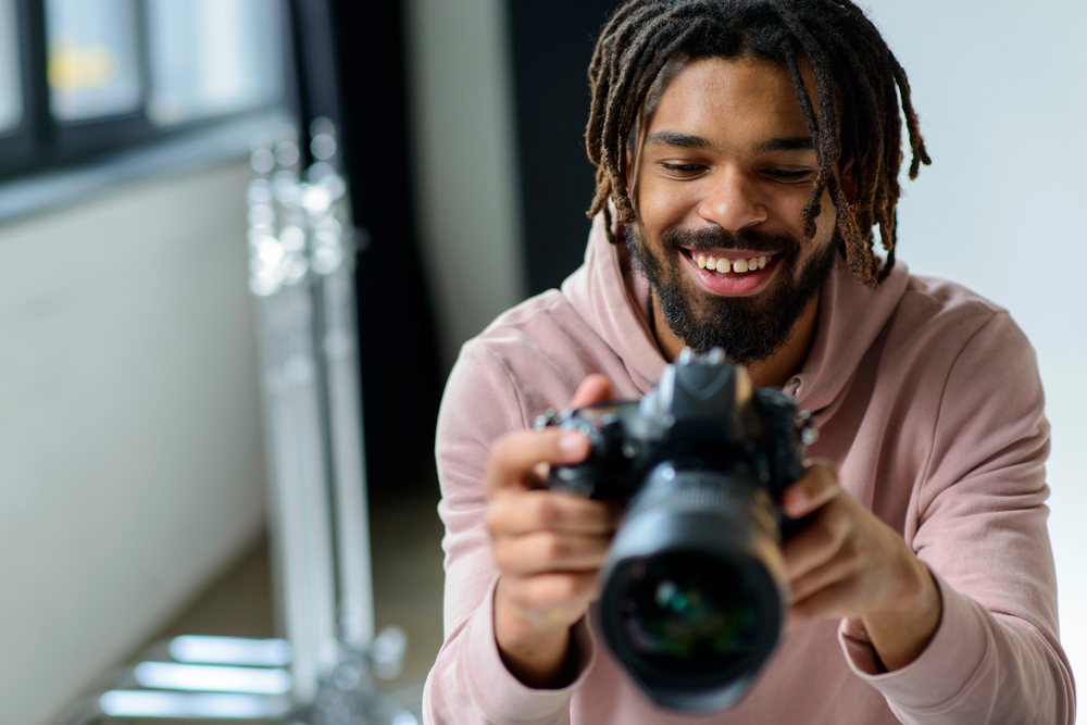 Smiling man looking at camera. Black man in photography studio.