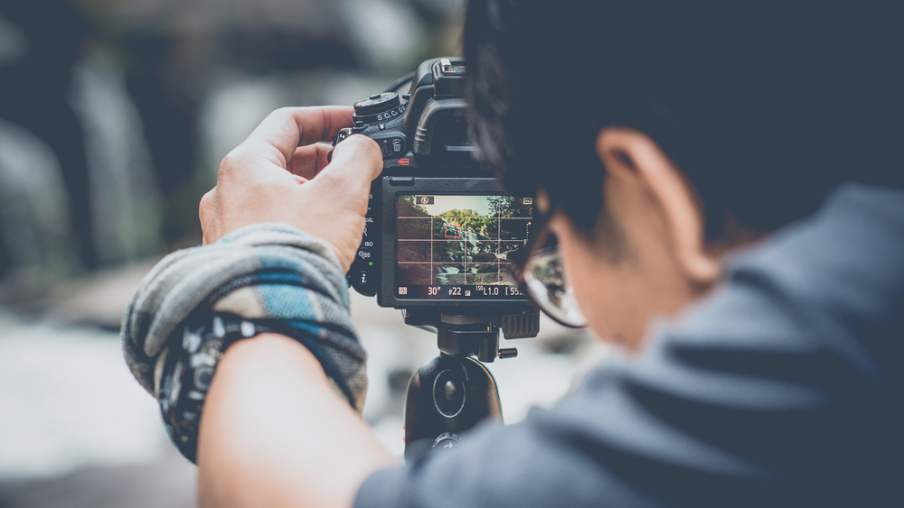 Photographer composing image on view screen