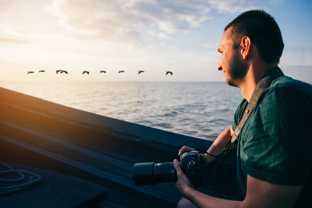 Photographer travelling by boat and watching the birds 