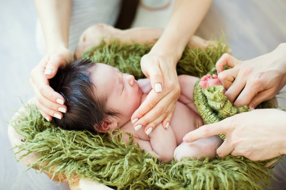 Posing and dressing a newborn baby