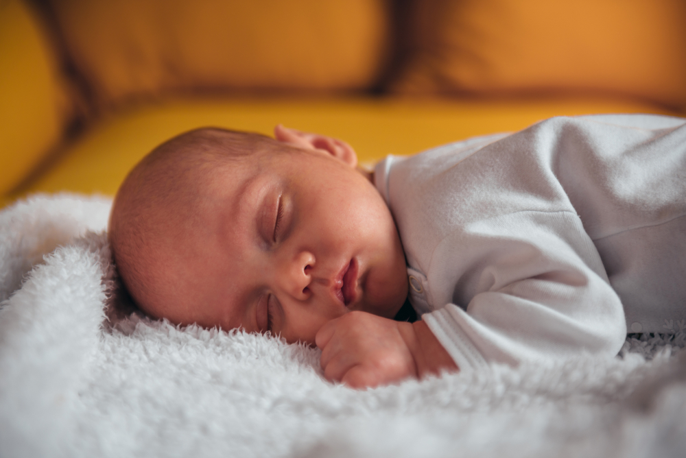 Sleeping Baby on a white soft blanket