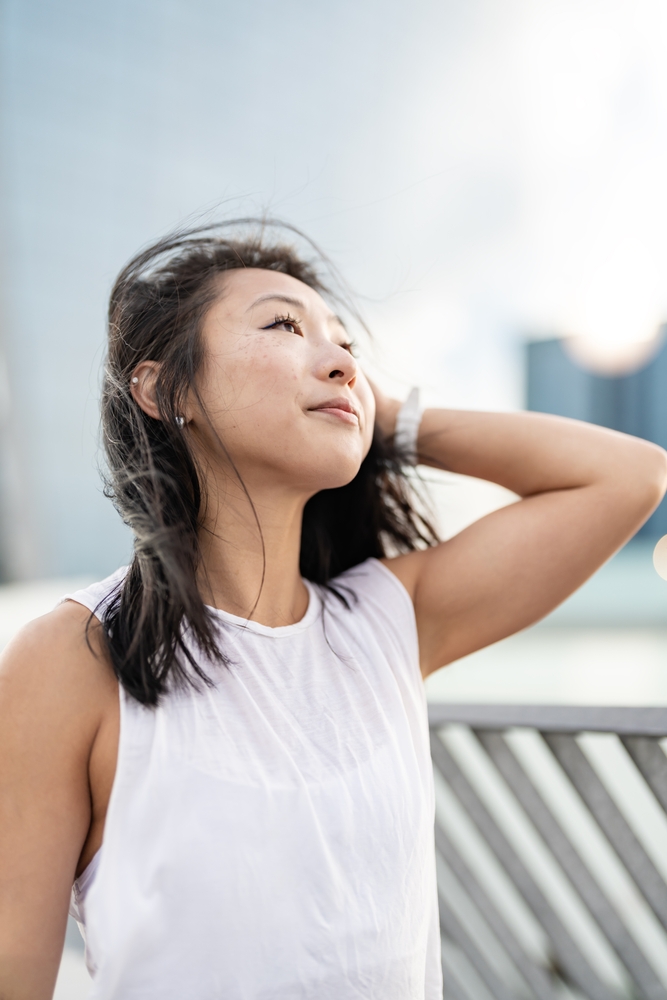 Urban portrait of a beautiful Asian ethnicity young sporty woman