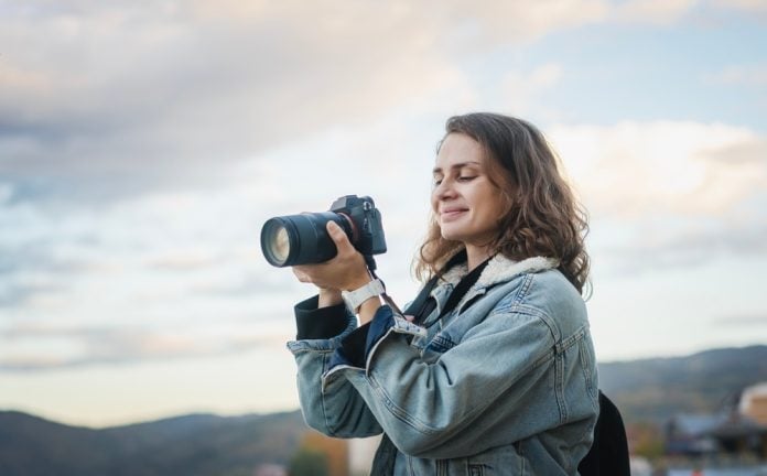 Woman holding DSLR