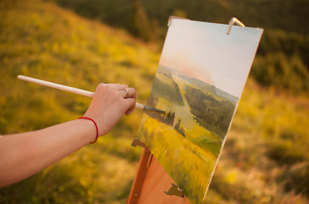 artist paints a landscape painting