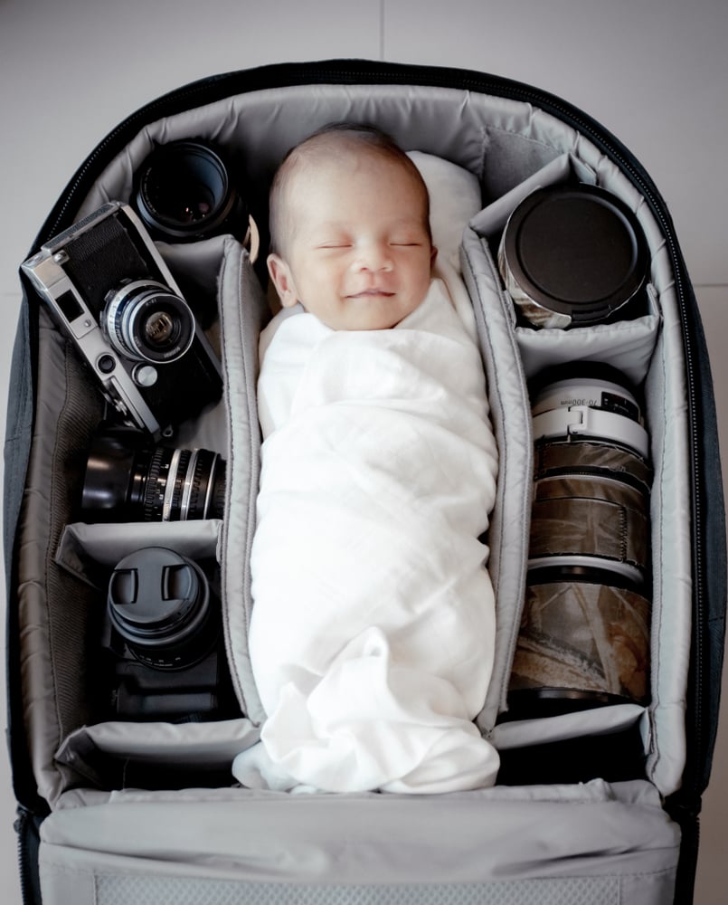 newborn in a camera bag