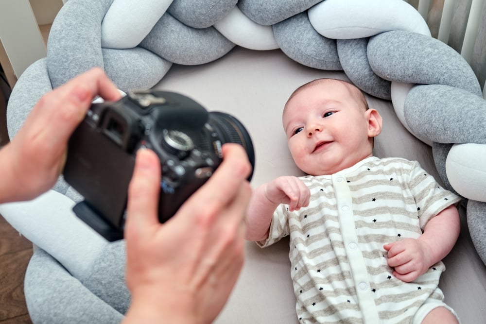 photographer takes pictures of a newborn baby with a camera