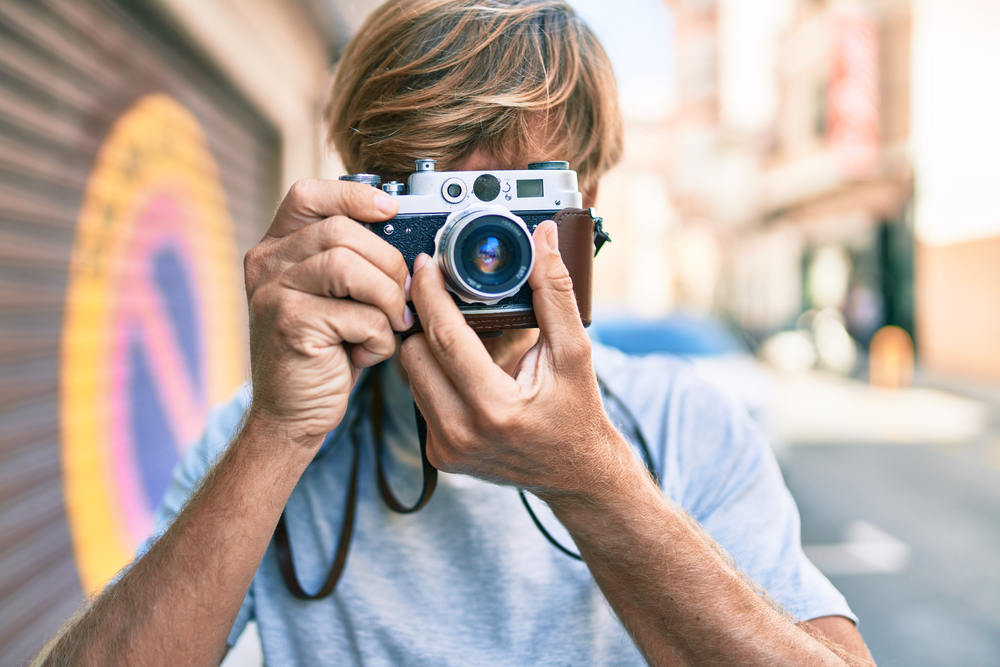 photographer  using vintage camera on a city street