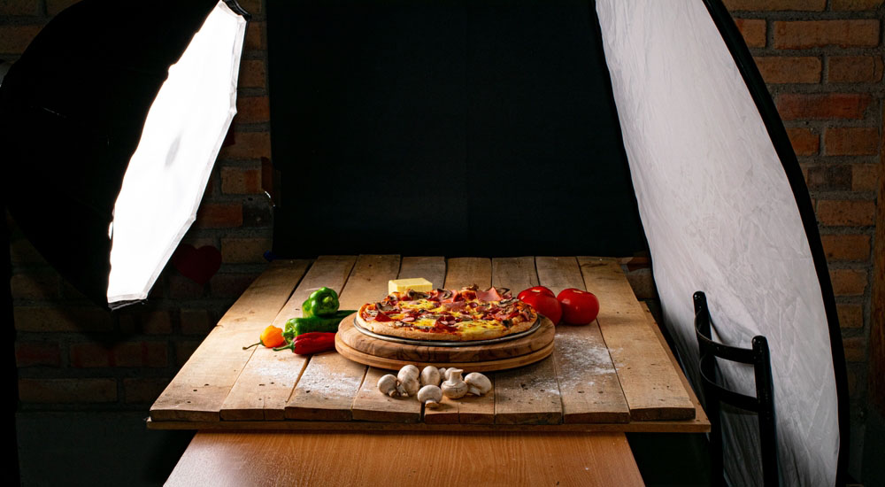 pizza on wood planks with photography lighting