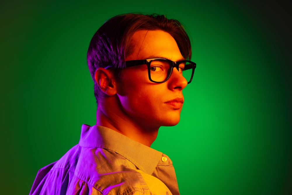 young man in stylish eyewear looking at camera