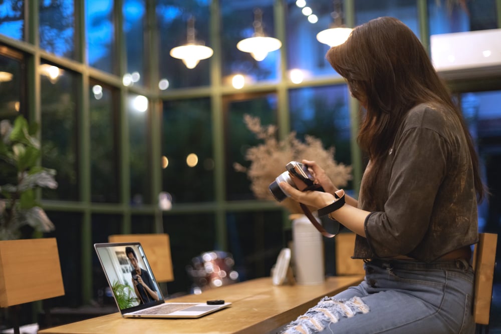 Woman learning to use a camera from online course